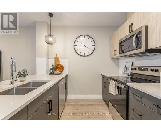 A kitchen with a sink, stove, and oven.