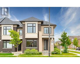 A modern two-story house with a large front yard.