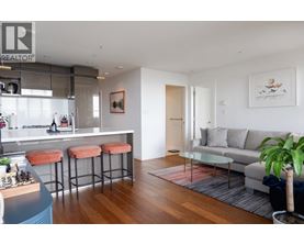 A modern living room with a bar area and a couch.