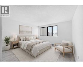 A bedroom with a large bed and a chair.