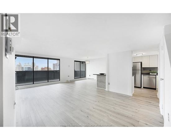 A spacious, modern kitchen with white cabinets and a large island.