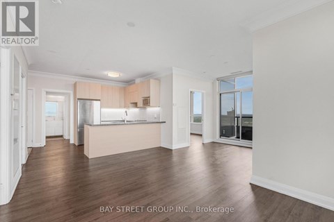 A spacious kitchen with white cabinets and a large island in the middle of the room.