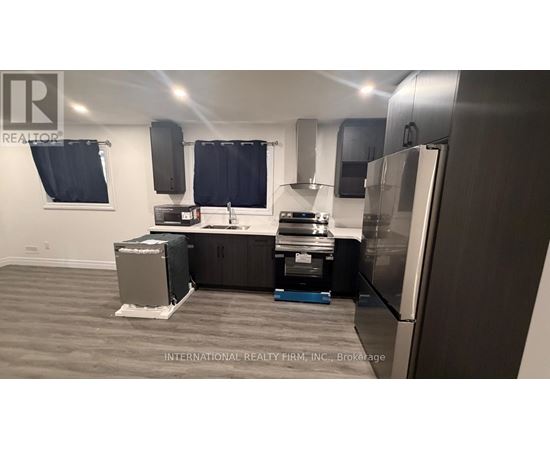 A kitchen with a refrigerator, stove, and oven.