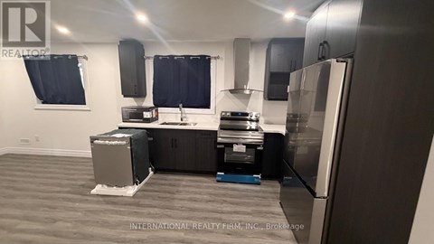 A kitchen with a refrigerator, stove, and oven.