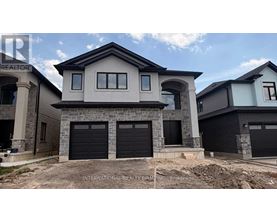 A modern house with a stone facade and black garage doors.