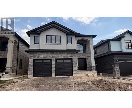 A modern house with a stone facade and black garage doors.