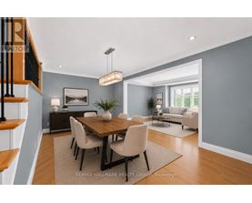 A dining room with a wooden table and chairs.