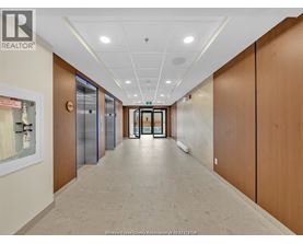 A hallway with wooden doors and a white ceiling.