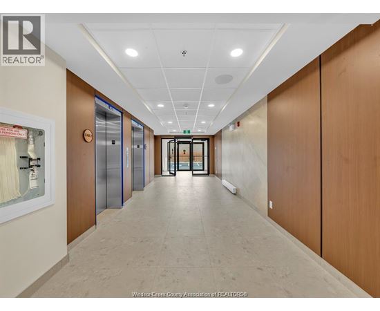 A hallway with wooden doors and a white ceiling.