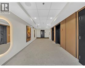 A hallway with a REALTOR® logo on the wall.