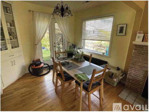 A dining room with a table and chairs.