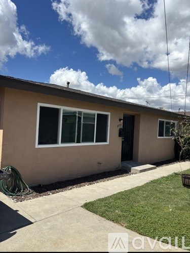 A house with a tan wall and a black door.