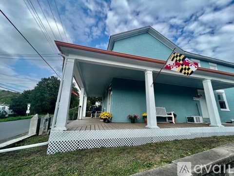 A blue building with a red roof and a flag on it.