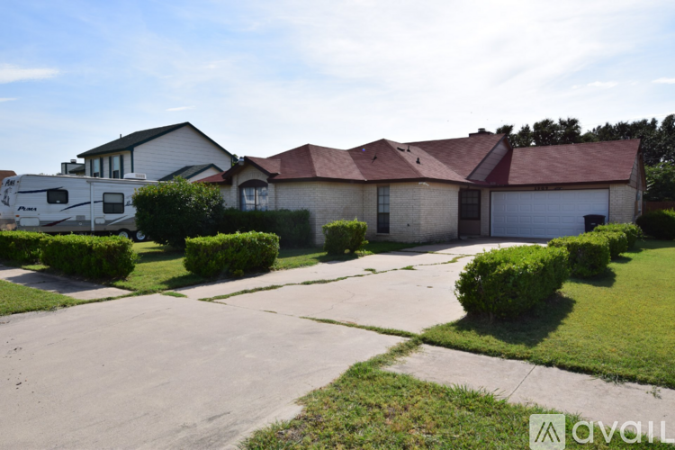 A house with a red roof and a white garage door is for sale.