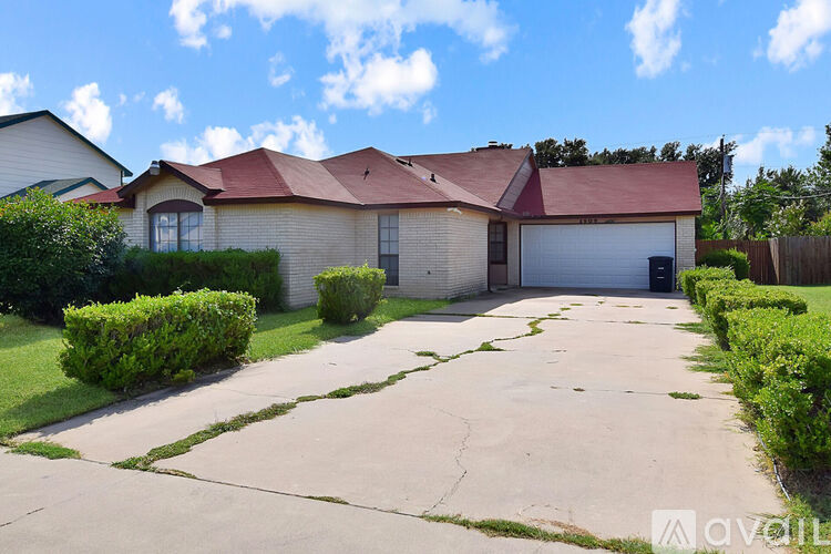 A house with a driveway in front of it.