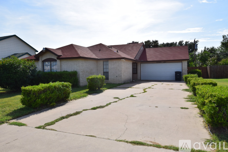 A house with a driveway in front of it.