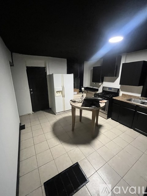 A kitchen with a table and chairs in the middle of the room.