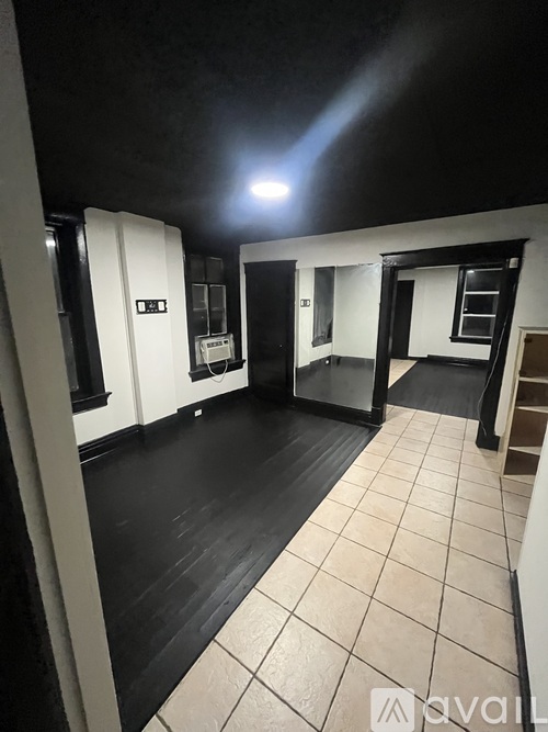A room with black flooring and white walls.
