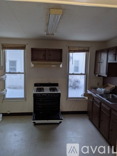 A kitchen with a stove and sink.