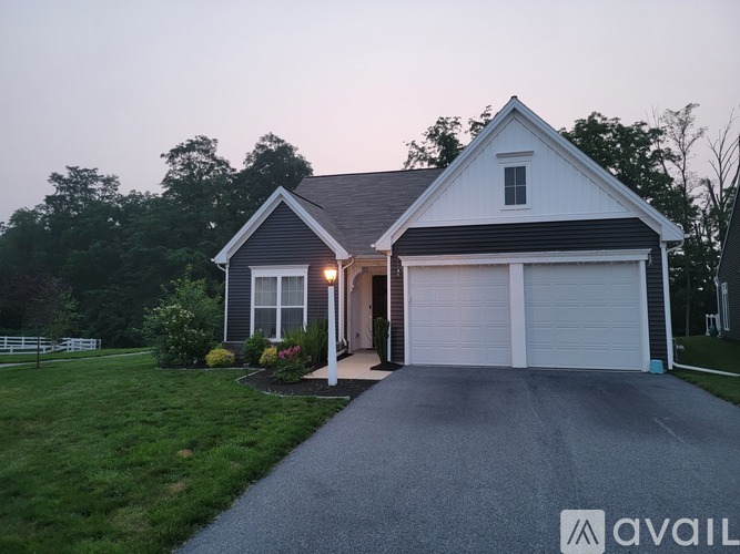 A house with a driveway leading to the garage.