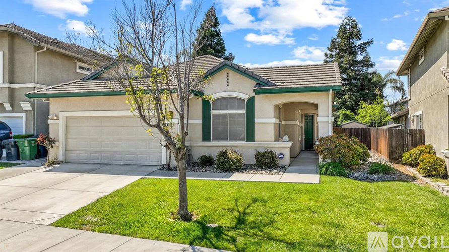 A house with a green tree in front of it.