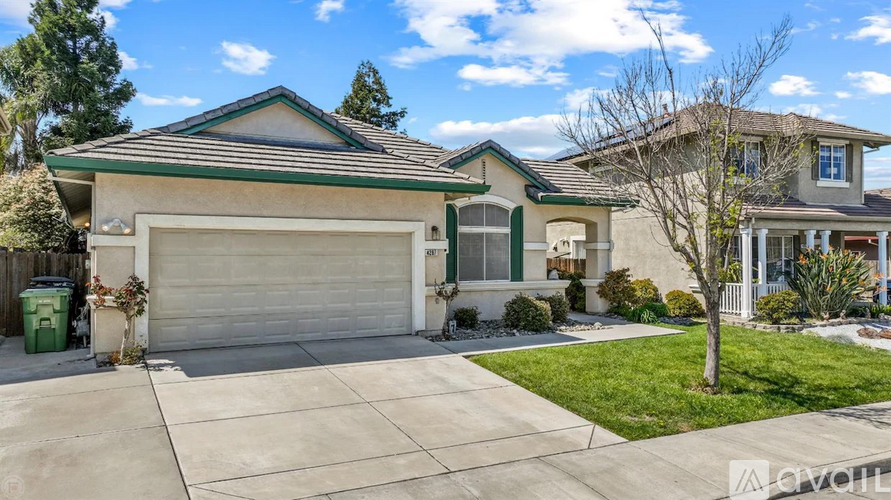 A house with a green roof and a white garage door.