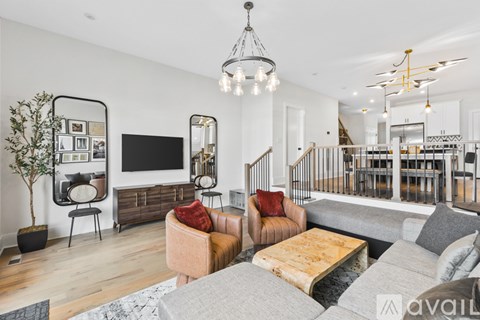 A living room with a grey couch and a wooden coffee table.
