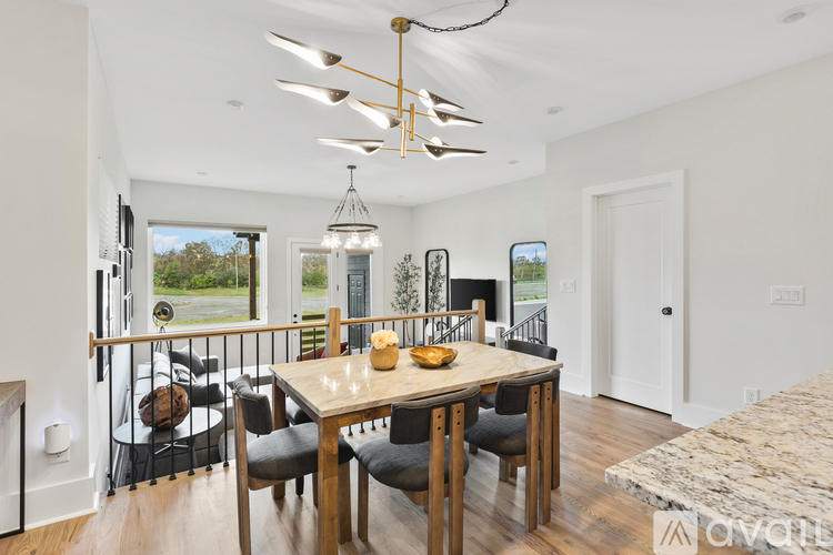A modern dining room with a wooden table and chairs.