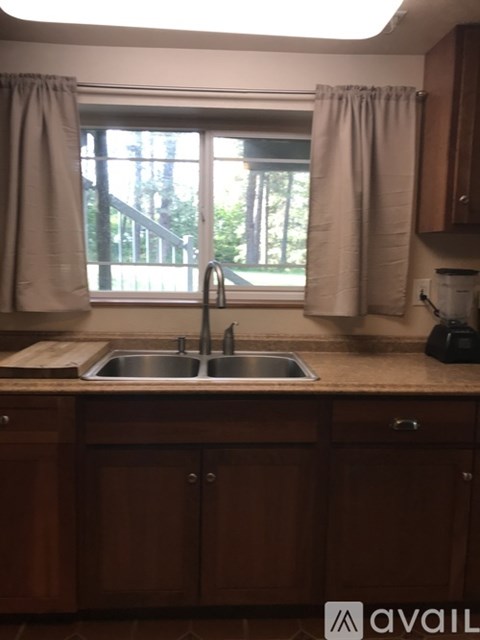 A kitchen with a sink and a window.