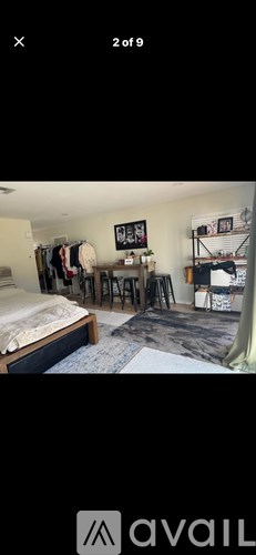 A room with a bed, a desk, and a chair.