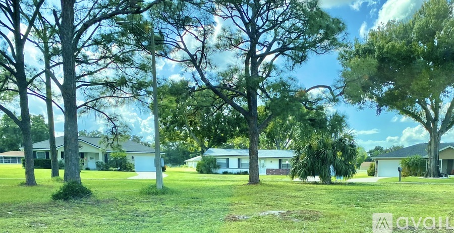 A row of houses with trees in front of them.