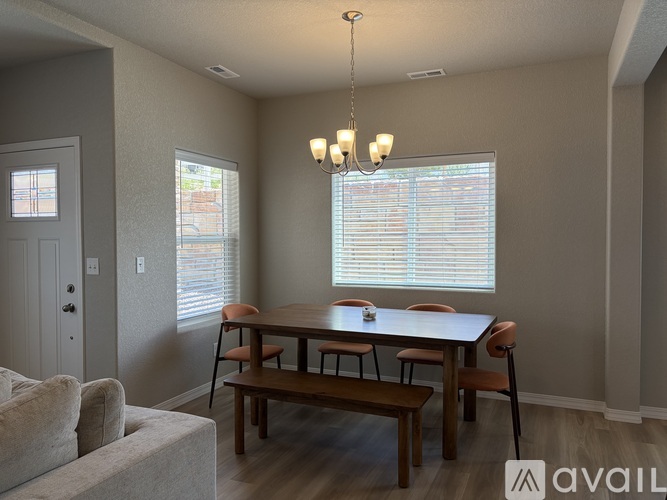 A dining room with a wooden table and chairs.