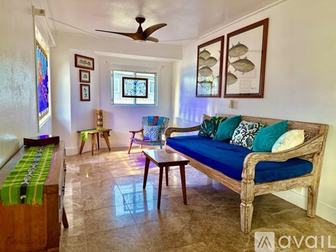 A living room with a blue couch and a wooden coffee table.