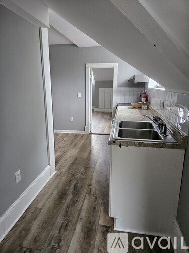 A kitchen with a sink and a countertop is under construction.