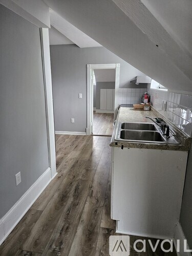 A kitchen with a sink and a countertop is under construction.