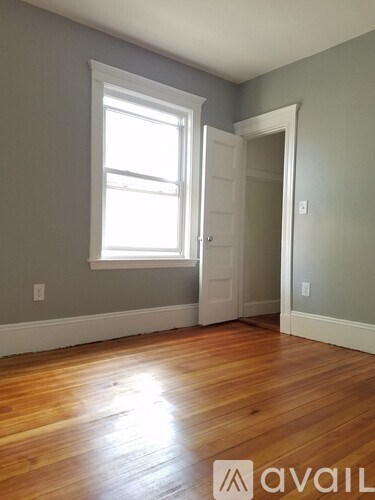 A room with wooden floors and a window.