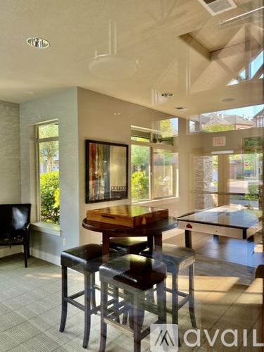 A modern dining room with a wooden table and chairs.
