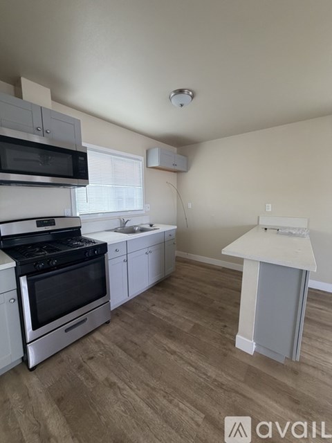 A kitchen with a stove top oven and microwave.