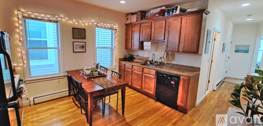 A kitchen with wooden floors and a table set for a meal.