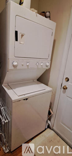 A white oven with a door open is in a room.