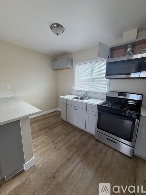 A kitchen with a stove top oven and microwave.