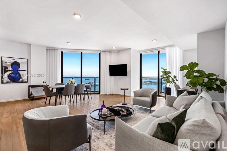 A living room with a couch, chairs, and a coffee table.