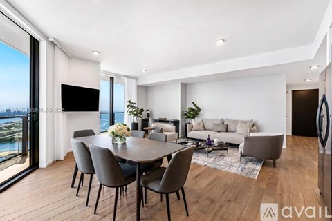 A modern dining room with a large table and chairs.