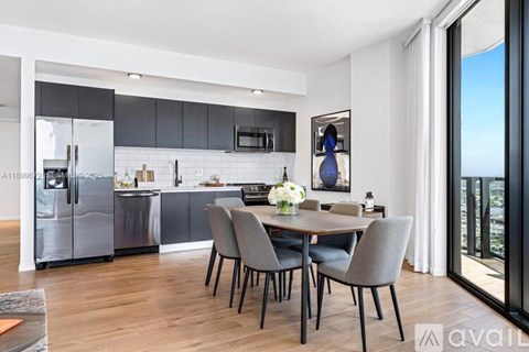 A modern kitchen with a dining table set for four.