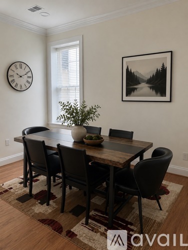 A dining room with a wooden table and chairs.