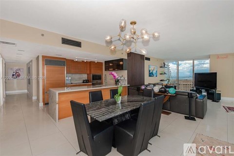A modern kitchen with a dining table set for four.