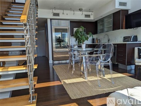 A modern kitchen with a dining table and chairs.