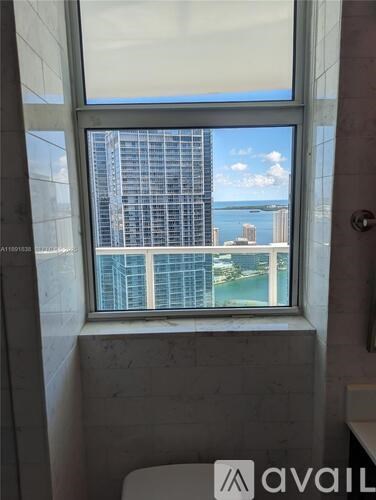 A window with a view of a cityscape and water.