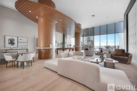 A modern living room with a large white sofa and a wooden curved structure.