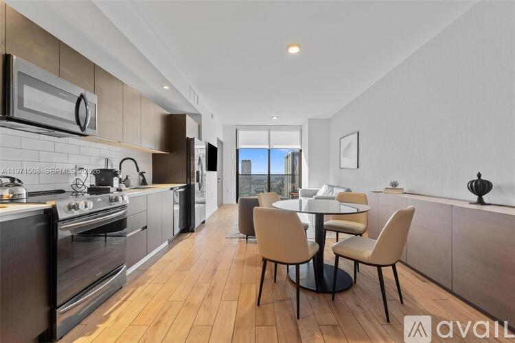 A modern kitchen with a dining table set for four.